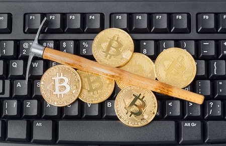 Computer and pickaxe on bitcoins - business backgroundの写真素材
