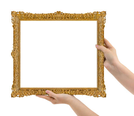 Wooden picture frame in hands isolated on white backgroundの写真素材