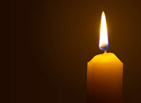 Macro of burning candle isolated on black backgroundの写真素材