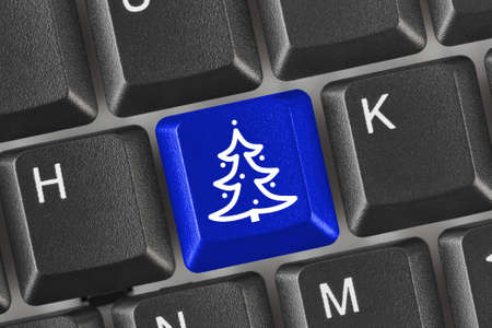 Computer keyboard with Christmas tree key - holiday conceptの写真素材
