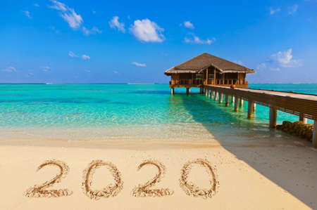 Numbers 2020 on beach - concept holiday background