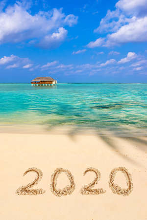 Numbers 2020 on beach - concept holiday background