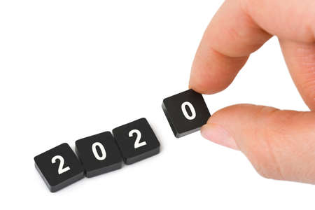 Numbers 2020 and hand isolated on white background