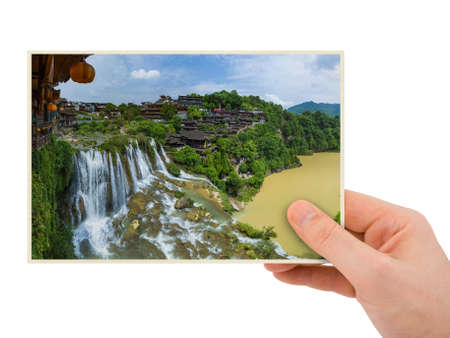 Hand and Furong ancient village and waterfall - Hunan China (my photo) isolated on white backgroundの写真素材