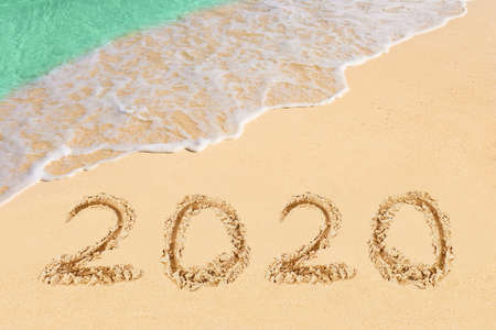 Numbers 2020 on beach - concept holiday background