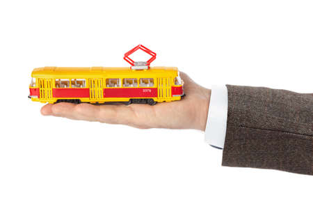 Hand with toy tram isolated on white backgroundの写真素材