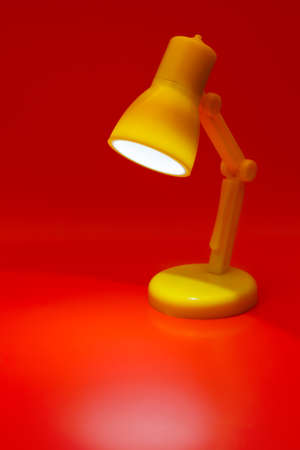 Desk lamp on red background