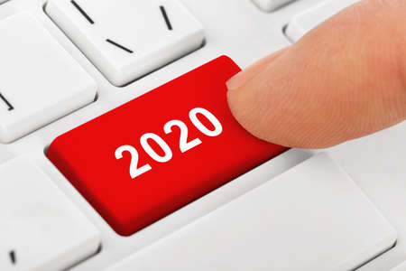 Computer notebook keyboard with 2020 key - holiday technology concept