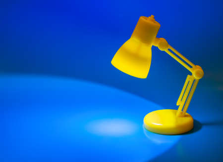 Desk lamp on blue backgroundの写真素材