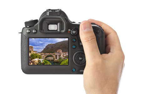 Hand with camera and Mostar - Bosnia and Herzegovina image (my photo) isolated on white background