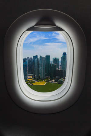 Singapore in airplane window - travel backgroundの写真素材