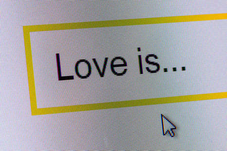 Words Love is... in search bar on computer monitor - technology background