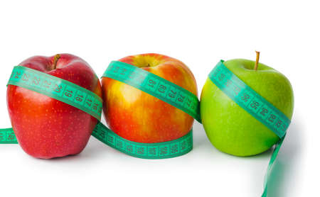 Apples and measuring tape isolated on white backgroundの写真素材