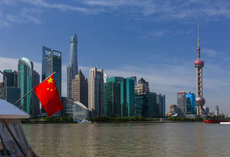 Shanghai, China - May 23, 2018: Chinese flag and modern Pudong skyline in Shanghai, China.のeditorial素材