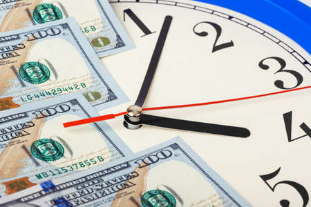 Clock and money - business concept background