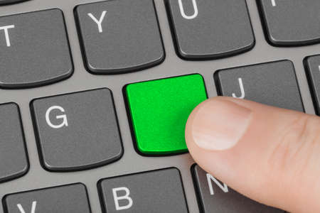 Computer notebook keyboard with blank green key - technology backgroundの写真素材