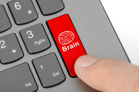 Computer keyboard with brain key - technology background