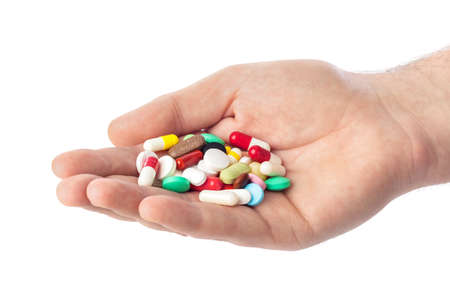 Hand with pills isolated on white background