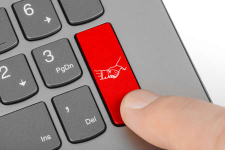 Computer keyboard with handshake button - technology background