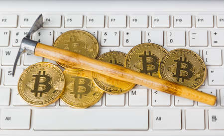 Computer and pickaxe on bitcoins - business backgroundの写真素材
