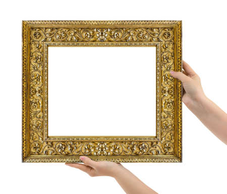Wooden picture frame in hands isolated on white backgroundの写真素材
