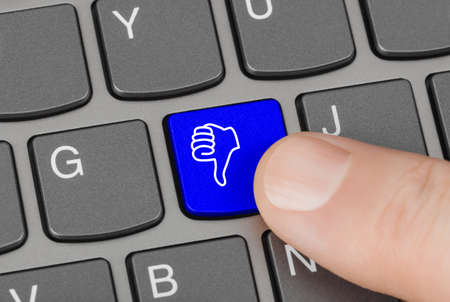 Computer keyboard with thumb gesturing hand keyの写真素材