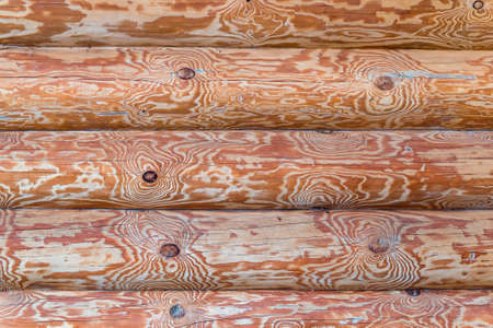 Wall of logs of a wooden house - abstract architecture backgroundの写真素材