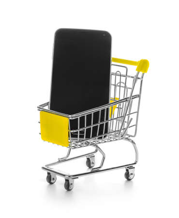 Smartphone in shopping cart isolated on white backgroundの写真素材