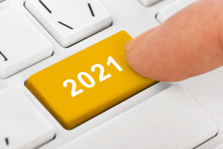Computer notebook keyboard with 2021 key - holiday technology conceptの写真素材