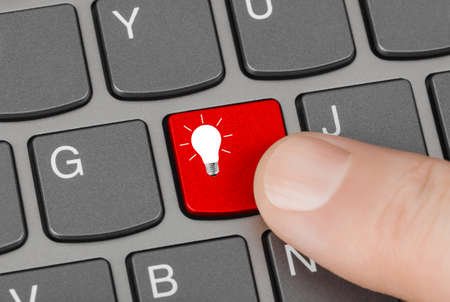 Computer keyboard with lamp key - technology backgroundの写真素材