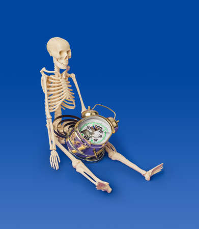 Skeleton and broken clock isolated on blue backgroundの写真素材