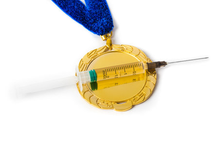 Gold medal and syringe isolated on white backgroundの写真素材