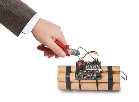 Hand with pliers and dynamite bomb isolated on white backgroundの写真素材