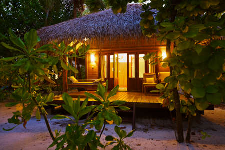 Beach bungalow at sunset - Maldives vacation backgroundのeditorial素材
