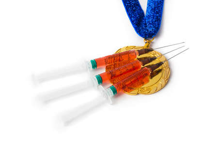 Gold medal and syringes isolated on white background