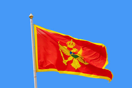 Montenegro flag - isolated on blue backgroundの写真素材