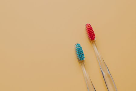 Shot of two new manual toothbruhes against yellow background with copy space for your promotional...