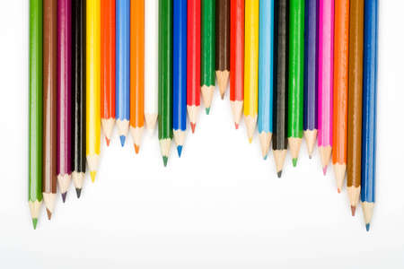 Assortment of coloured pencils with shadow on white backgroundの写真素材