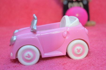 pink children toy car model  on pink backgroundの写真素材