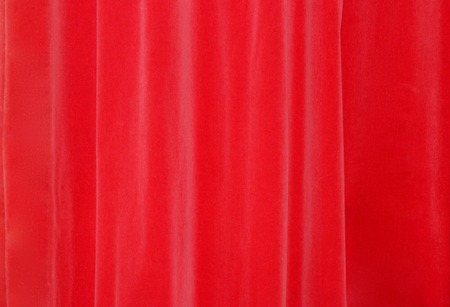 Closed beautiful red theater silk curtain background with wave backgroundの写真素材