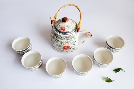 beautiful teapot and teacups on white backgroundの写真素材