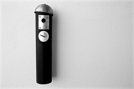 discarded cigarette that hung on the wallの写真素材
