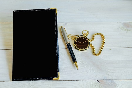 notebook black color with pen and pocket watchの写真素材