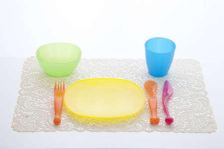 Colorful plastic dining set orange  yellow  green  blue  pinkの写真素材