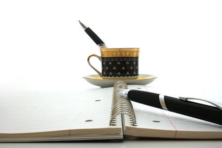 Notebook, handles and a coffee cup - the end of the working day.の写真素材