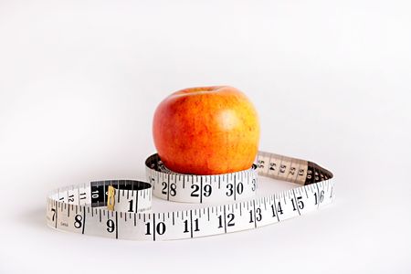 Tape measure and an apple characterise diet possibility.の写真素材