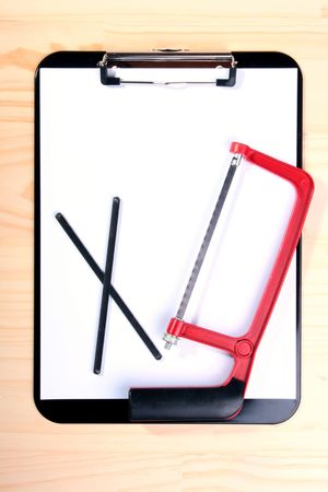Saw on metal with spare files against Blank Clipboard.の写真素材