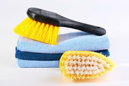 Two brushes for cleaning of a premise and a set of soft rags in a dark blue tonality.の写真素材
