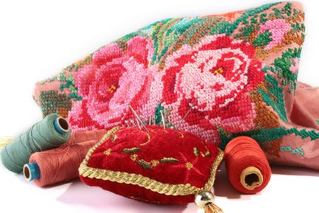 Cloth embroidered with a dagger and a set for needlework, threads and needles on a pillow for...