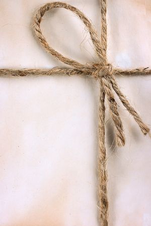 The ancient package is tied by a cord with a bow.